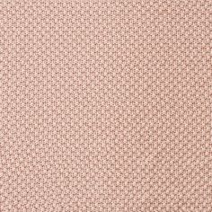 a close up view of a pink and white knitted fabric with small circles on it