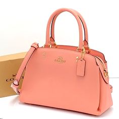 Coach Mini Lillie Carryall Gold/Candy Pink Crossgrain Leather Center Zip Compartment Snap Closure, Fabric Lining Handles With 4 1/4" Drop Outside Open Pocket Detachable Strap With 21 1/2" Drop For Shoulder Or Crossbody Wear Four Protective Feet At Base 10 1/4" (L) 6 3/4" (H) 4 1/4" (W) Style No. 91146 Coach Editor's Notes Our Crossgrain Leather Mini Lillie Carryall Is A Structured Go-Anywhere Bag Featuring Top Handles And A Detachable Strap For Everyday Versatility. Classic Pink Handheld Shoulder Bag, Classic Pink Top Handle Satchel, Pink Rectangular Coach Satchel, Coach Pink Crossbody Satchel, Classic Pink Satchel With Top Carry Handle, Classic Pink Satchel With Top Handle, Classic Pink Satchel With Detachable Strap, Pink Satchel For Errands, Pink Coach Top Handle Satchel