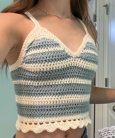 a woman is wearing a crocheted crop top