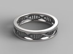 a wedding ring with an intricate design on the outside and inside, sitting on a gray surface