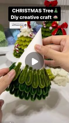 someone is making a christmas tree out of paper