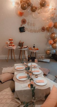 a table set up for a party with balloons and plates