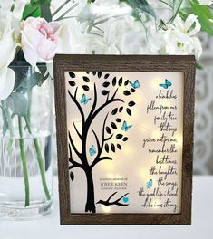 a wooden frame with a tree and butterflies on it