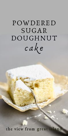 a piece of powdered sugar doughnut cake on a plate next to a fork