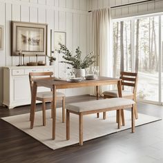 a dining room table with two chairs and a bench