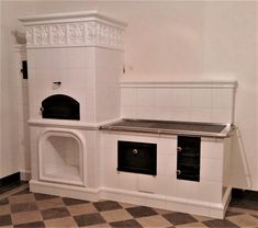 an old fashioned stove and oven in a room with checkered flooring on the ground