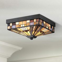 a ceiling light that has stained glass shades on the top and bottom half of it