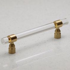 two brass and glass candlesticks on a white surface