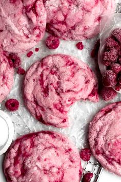 raspberry cookies with powdered sugar on top and spoons next to them