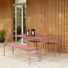 a table and two chairs on a wooden deck