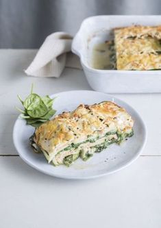 a white plate topped with a slice of quiche next to a casserole dish