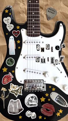 an electric guitar with many stickers on it