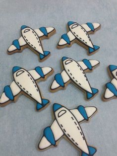 six decorated cookies in the shape of airplanes