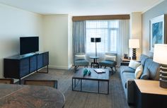 a living room filled with furniture and a flat screen tv