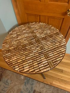 a table made out of bamboo sticks on top of a wooden floor next to a door