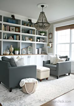 a living room filled with furniture and lots of bookshelves on top of it