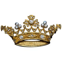 Circa 1890s This Belle Epoque openwork gold brooch is finely modeled as a royal crown embellished with pearls, old mine and rose cut diamonds. The three principal diamonds are bright white (E-F color) old mine cut stones with approximate weight of 0.23 ct, 0.19 ct, 0.17 ct (VS1, VS2, SI2 clarity). Estimated total diamond weight is 1.06 carat. Length 55 mm (2 3/16 in.) Height 29 mm (1 1/8 in.) The brooch is almost certainly a royal presentation piece. Antique Crown, Crown Brooch, Expensive Jewelry Luxury, Diamond Crown, Garnet And Gold, Gold Brooch, Antique Brooches, Diamond Brooch, Expensive Jewelry