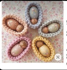 four small crocheted eggs in the shape of mice on a floral tablecloth