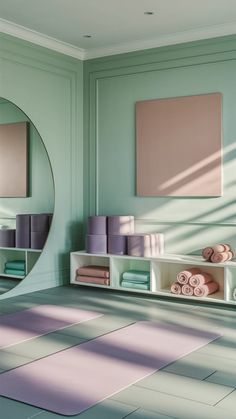 a bathroom with green walls and pink towels on the shelf next to it, in front of a round mirror