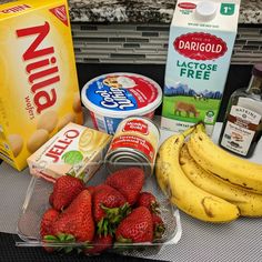 bananas, yogurt, strawberries, and other food items on a counter