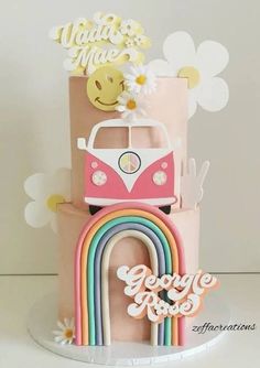 a cake with a vw bus and rainbows on it