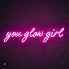 a neon sign that says, you glow girl on the side of a dark wall