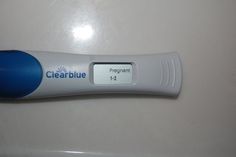 an electronic thermometer sitting on top of a white table next to a blue marker