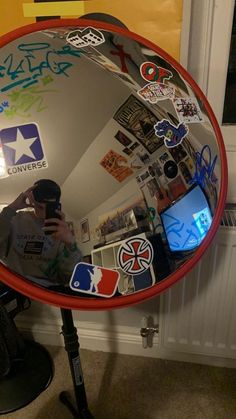 a person taking a selfie in front of a mirror with stickers all over it