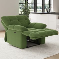 a green recliner sitting on top of a white rug