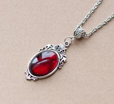 This Victorian inspired necklace is made from a dark red glass cabochon housed in an ornate filigree setting. -the chain is 18 inches long -the pendant is approximately 2 inches long and 1.5 inch wide including the setting -lobster claw closure -Available in antique silver and bronze finish SHIPPING: CANADA: Default shipping within Canada is by letter mail, no tracking, takes 1-2 weeks USA: Tracked Packet, includes tracking : 1-2 weeks Europe: Default shipping is by air mail, without tracking, 2 Cabochon Necklace, Red Pendants, Filigree Jewelry, Vintage Inspired Jewelry, Gothic Necklace, Inspired Necklace, Victorian Design, Filigree Pendant, Cameo Necklace