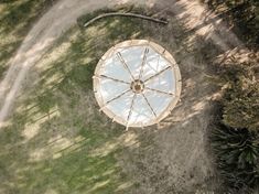 an aerial view of a small white umbrella in the grass