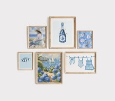 four framed pictures with blue and white artwork hanging on the wall next to each other