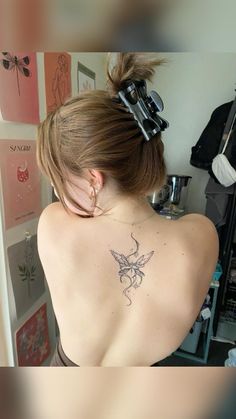 a woman with a tattoo on her back