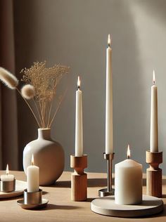 candles and vases are arranged on a table