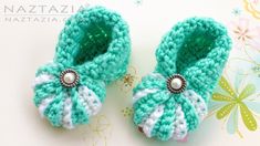 two crocheted baby shoes with pearls on them