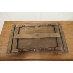 an old wooden tray sitting on top of a table