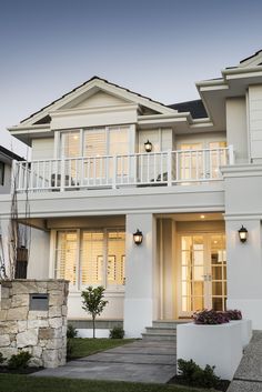 a large white house with two balconies