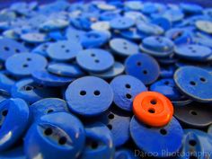 blue and orange buttons with an orange button on them are all over the place in this photo