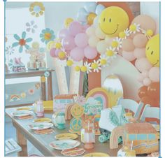 a table with balloons, plates and other items for a child's birthday party