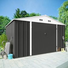 an image of a garage that is in the middle of a yard with landscaping equipment