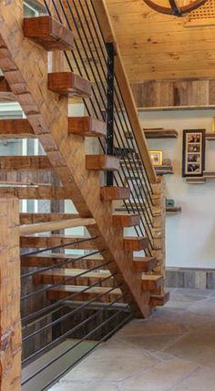 the inside of a house with wooden stairs