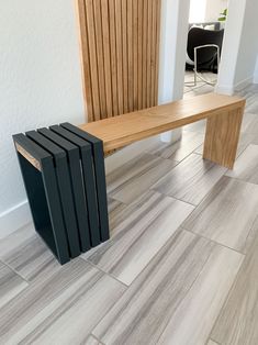 a wooden bench sitting on top of a tiled floor