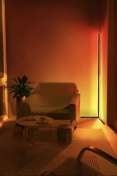 a living room filled with furniture and a neon light on the wall above it's doorway