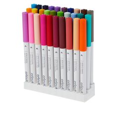 six different colored pens are lined up on a white display stand with the same color