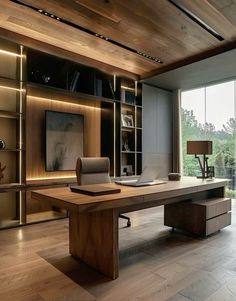 a large wooden desk sitting inside of a living room next to a glass wall with lots of windows