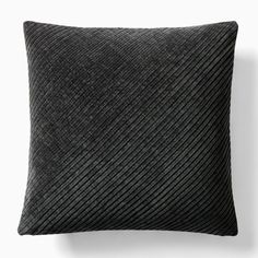 a black pillow on a white wall with a gray stripe pattern in the middle and bottom