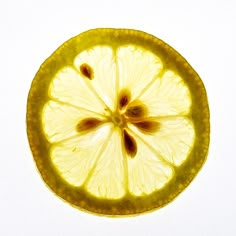 a slice of lemon sitting on top of a white table