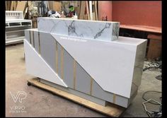 a marble counter with gold stripes on it in a shop setting, ready to be painted