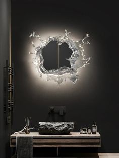 a bathroom with a sink, mirror and lights on the wall above it's counter