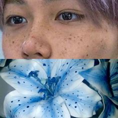 a woman with purple hair and blue flowers on her face, looking at the camera